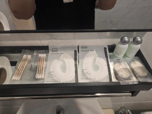 a glass shelf with different types of toothbrushes at แวะมาพักโคกกลอย Wae Ma Phak Khokkoi in Ban Huai Sai