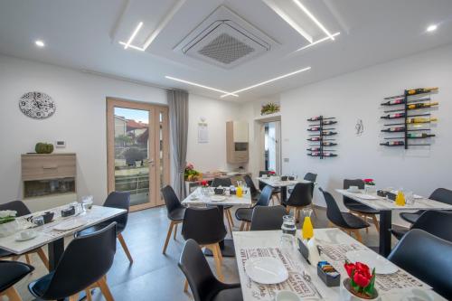 a dining room with tables and chairs and a room with a fireplace at Villavità in Agerola