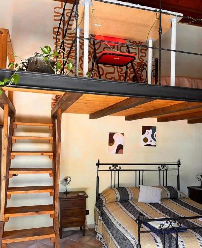 a bedroom with a bunk bed and a staircase at Mandra Chiusilla in Collesano