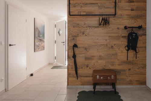 a hallway with a wooden wall with a camera on it at Chalet Ferienwohnung zwischen Berchtesgaden und Ramsau in Bischofswiesen