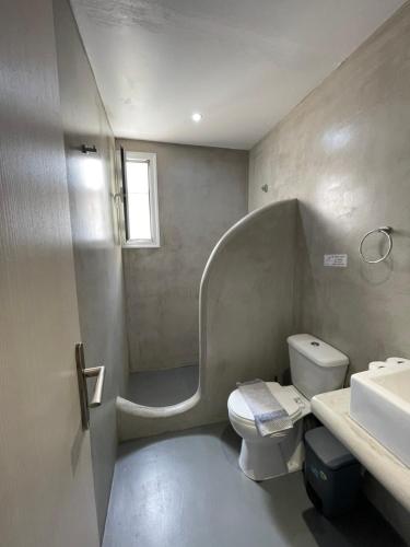 a bathroom with a toilet and a sink at Passos Rooms in Parikia
