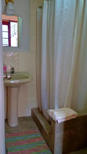 a bathroom with a shower curtain and a sink at Hospedaje Totocha Yanahuara Arequipa in Yanahuara