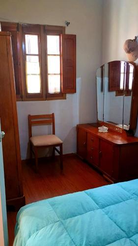 a bedroom with a bed and a dresser and a chair at Hospedaje Totocha Yanahuara Arequipa in Yanahuara