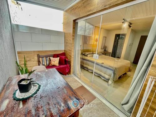 a bedroom with a bed and a table in a room at Samburá Residece By 123Quarto in Camalaú