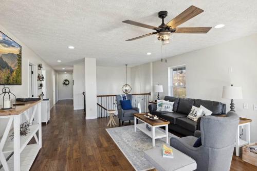 a living room with a couch and a ceiling fan at Spacious 4 bd with hottub, theater & game zone in Union Grove