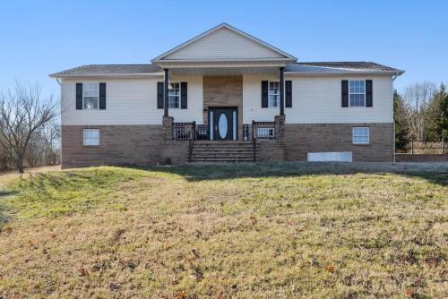 a house with a large yard in front of it at Spacious 4 bd with hottub, theater & game zone in Union Grove