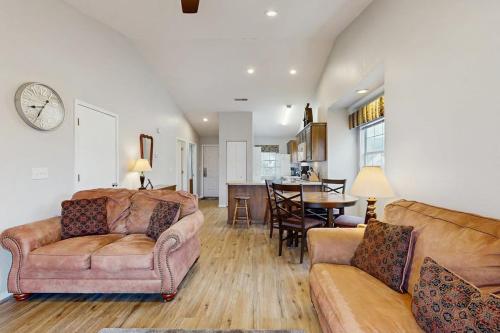 a living room with two couches and a dining room at Lantern Bay Retreat in Branson