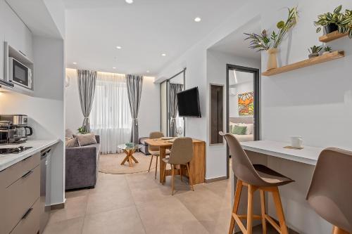 a kitchen and living room with a table and chairs at Athens Theatrou Apartments in Athens