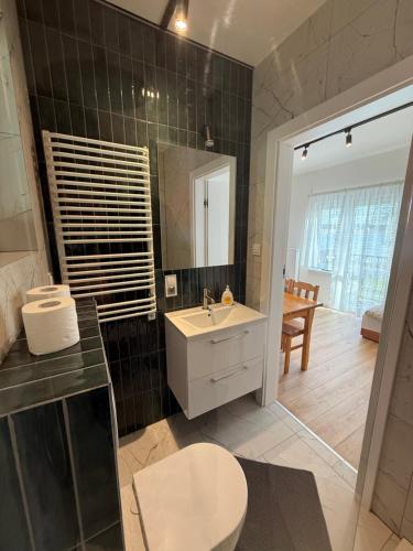 a bathroom with a sink and a mirror at Pokoje U rybaka in Stężyca
