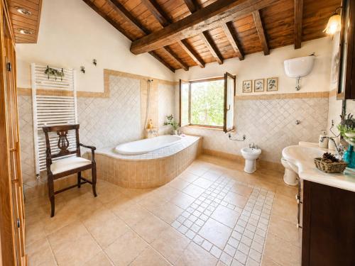 a bathroom with a tub and a toilet and a sink at VILLA NOCRI - Villa Privata con Piscina & Sauna in Montefranco