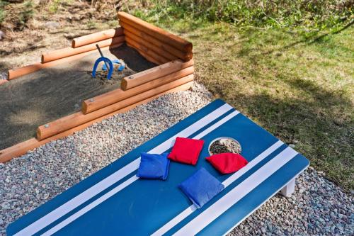 a blue bench with red and blue pillows on it at Glacier Cabins in Martin City