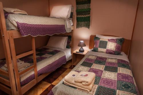 a bedroom with two bunk beds and a lamp at Cordillera Azul in Puerto Natales