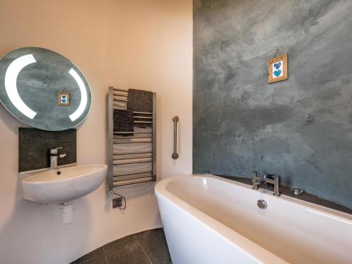 a bathroom with a sink and a tub and a mirror at 3 Bed in Kinross oc-55935 in Kinross