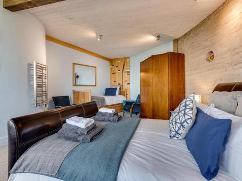 a bedroom with a large bed with blue pillows at 3 Bed in Kinross oc-55935 in Kinross
