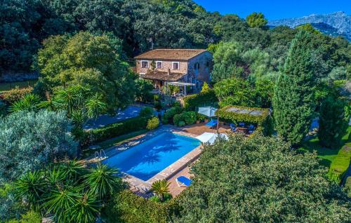 an aerial view of a house with a pool and trees at Ca Les Estamenyes in Pollença