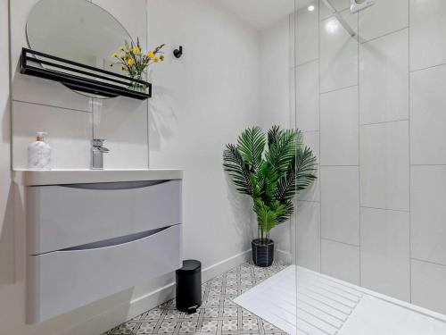 a bathroom with a sink and a potted plant at 1 Bed in Redruth oc-92281 in Redruth
