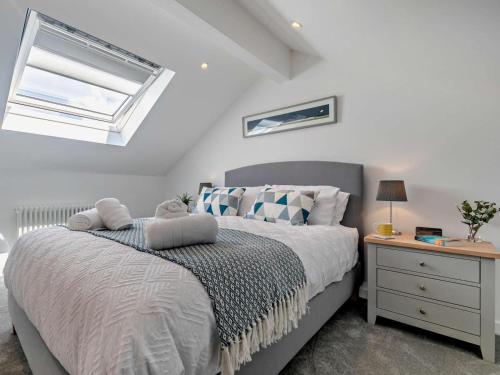 a bedroom with a bed with a nightstand and a window at 1 Bed in Redruth oc-92281 in Redruth