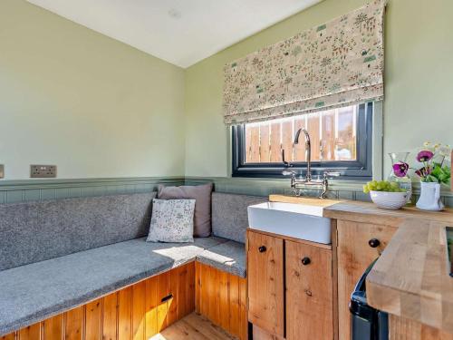 a kitchen with a bench with a sink and a window at 1 Bed in Hawarden oc-93595 in Hawarden