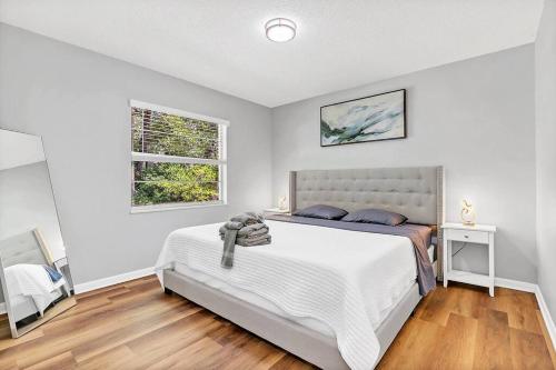 a bedroom with a large bed and a window at Blue Spring Getaway with Fire Pit in Orange City