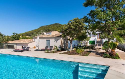 a villa with a swimming pool in front of a house at Mater Randa in Algaida