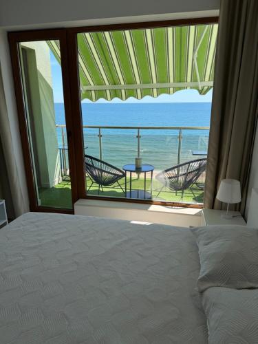 a bedroom with a bed and a view of the ocean at Kabakum See infinity in Varna City