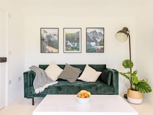 a green couch in a living room with a table at 1 Bed in Manningtree oc-78389 in Lawford