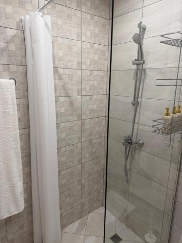 a shower with a glass door in a bathroom at Kabakum See infinity in Varna City