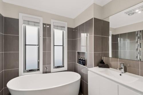 a bathroom with a white tub and a sink at Scenic Shores in Budgewoi