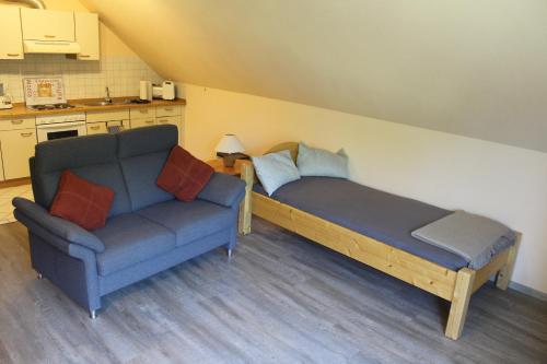 a living room with a couch and a couch and a table at Steenshof in Heringsdorf