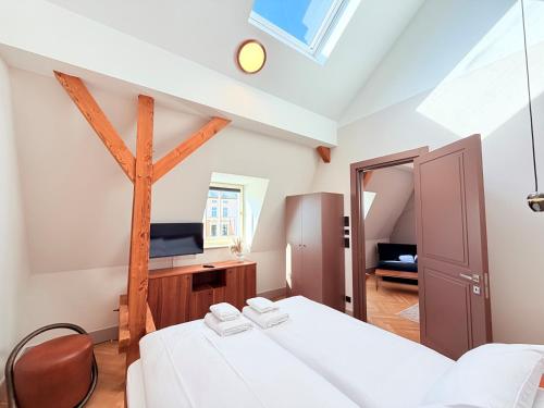 a attic bedroom with two beds and a tv at Amaroo - Boarding & Serviced Apartments "Regia" in Potsdam
