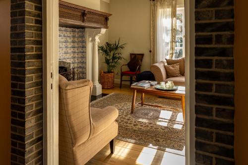 a living room with a chair and a table at B&B Dreamcottage in Knokke-Heist