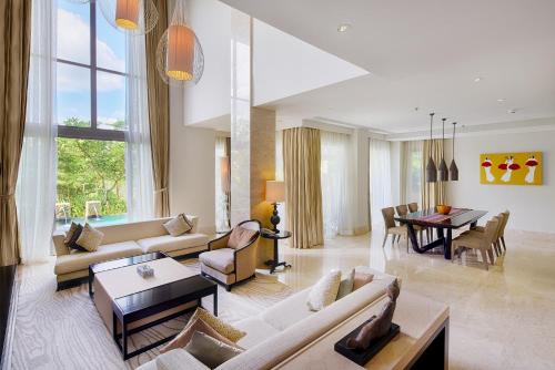 a living room with a couch and a table at Luxury Apartment at AYANA Residences in Jimbaran