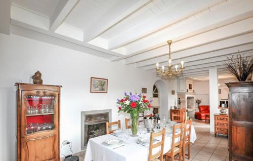 a dining room with a table and chairs and a fireplace at Authentique Maison Piscine in Saint-Amans-Valtoret