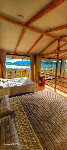 a large bedroom with two beds and a view of the ocean at Mirador el Prado in Cheqquerec