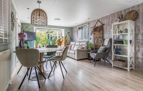 a living room with a table and chairs and a couch at Nice Home In Erm With Wifi in Erm