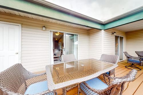 a patio with a table and chairs on a porch at Lake Adventures at Eagle's Nest in Branson