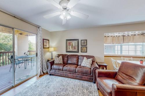 a living room with a couch and a table at Treetop Tranquility in Branson