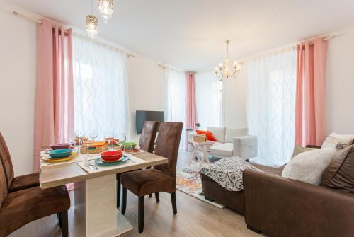 a living room with a table and a couch at White Tiles in City Center in Lisbon