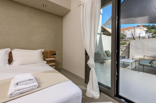 a bedroom with a bed and a large window at The Old Port in Limenas