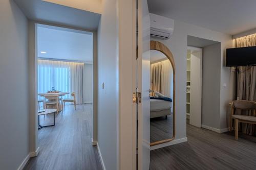 a room with a mirror and a bedroom with a bed at Azor Signature Flats - III in Ponta Delgada