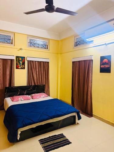 a bedroom with a bed and a ceiling fan at Moon Villa Homestay in Nowgong