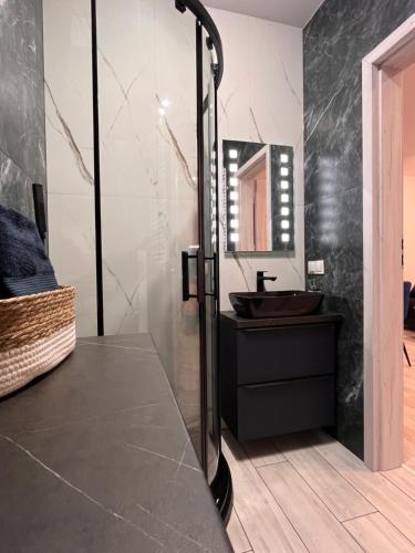 a bathroom with a sink and a mirror at Apartament Raj in Biała Podlaska