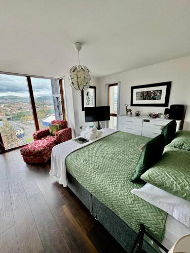 a bedroom with a large bed and a large window at James Clow Boutique Bed & Breakfast in Belfast