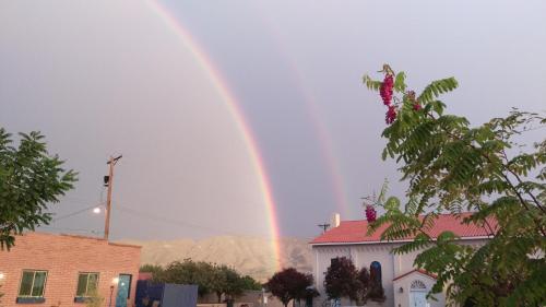 a rainbow in the sky over a building at Rocket Inn in Truth or Consequences