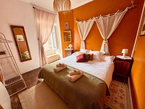 a bedroom with a bed with two towels on it at Maison Luard in Bedous