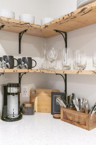 a kitchen shelf with glasses and utensils on it at 6th Ave district studio Quiet Prkng in Tacoma
