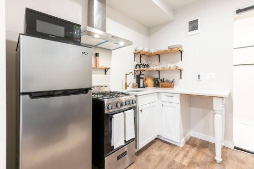 a kitchen with a refrigerator and a stove at 6th Ave district studio Quiet Prkng in Tacoma