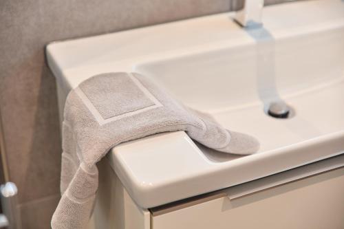a towel sitting on the edge of a bathroom sink at Burgblick Apartment Weinlaub in Bernkastel-Kues