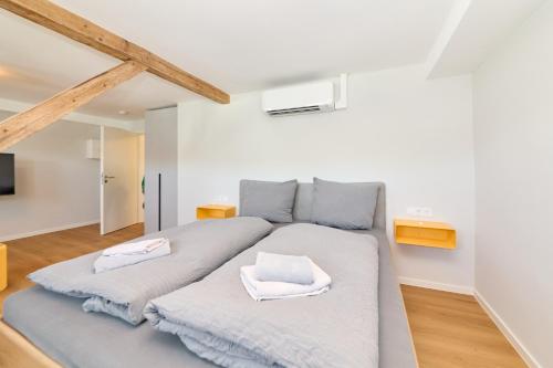 a bedroom with a large bed with two towels on it at Burgblick Appartement Riesling Gold in Bernkastel-Kues