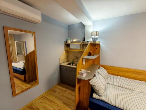 a small room with a bed and a mirror at Skalolazka 2 in Belogradchik